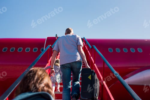 Preview: Family boarding an airplane on a sunny day