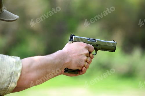 Preview: Soldier taking aim with an automatic pistol