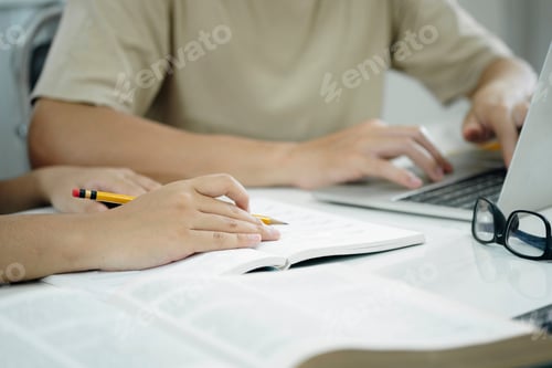 Preview: Young woman and man studying for a test or an exam. Tutor books with friends. Young students campus