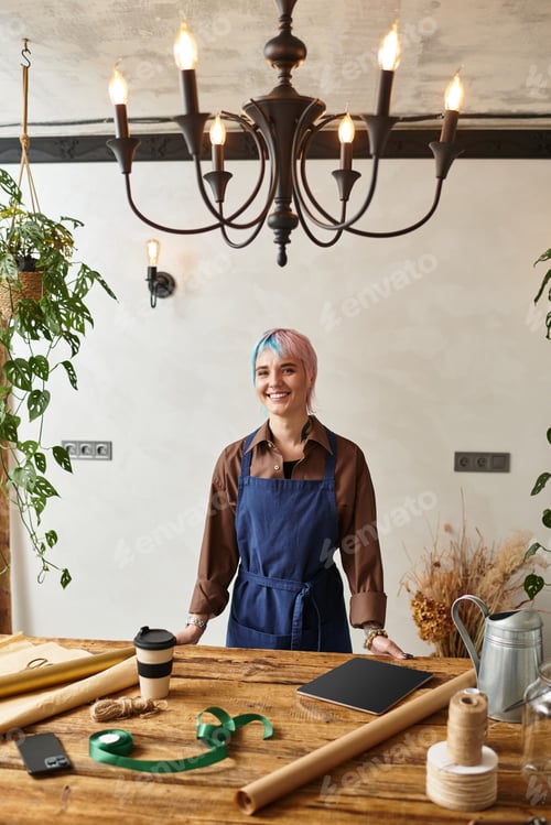 Preview: Creative florist enjoys her craft in a vibrant flower shop with unique decor elements