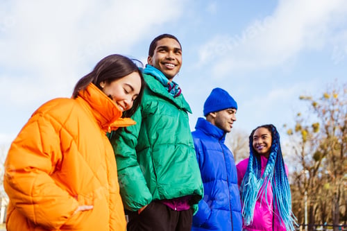 Preview: Multiracial group of young friends meeting outdoors in winter