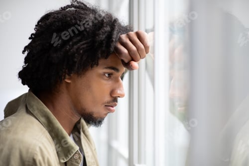 Preview: Depression Concept. Portrait Of Pensive Upset Young Black Man Looking Out Window