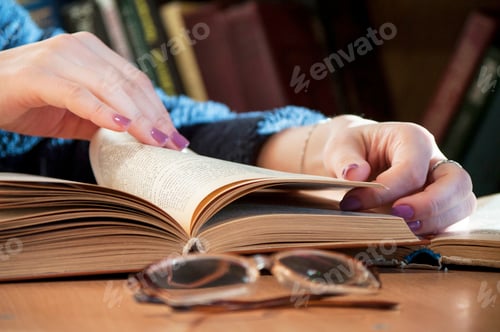 Preview: girl reading a book in the library