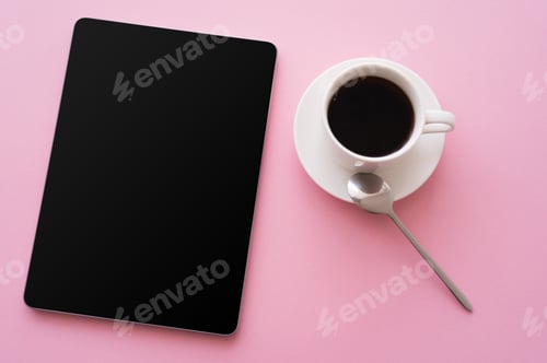 Preview: top view of digital tablet with blank screen near cup of coffee on pink