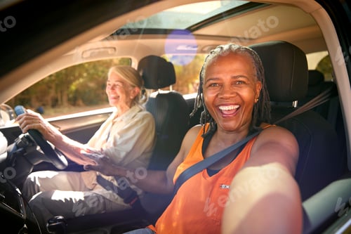 Preview: POV Shot As Passenger Takes Selfie On Phone As Two Senior Female Friends Enjoy Day Out In Car