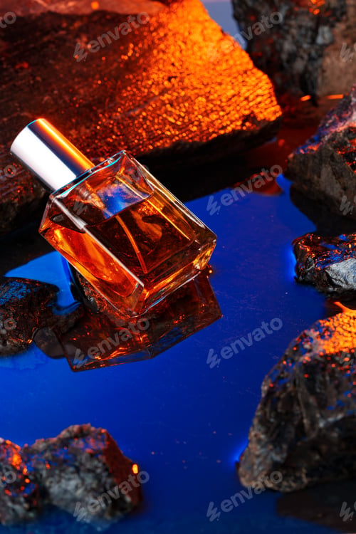 Preview: Bottle of perfume on a background of stones