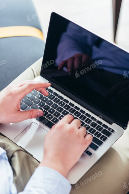 Preview: cropped shot of businessman using laptop with blank screen