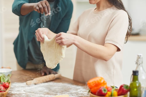 Preview: Couple preparing dough for pizza