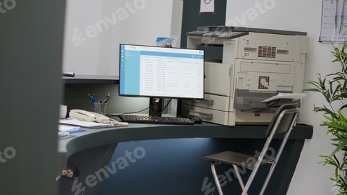 Preview: Empty reception counter at hospital lobby with computer