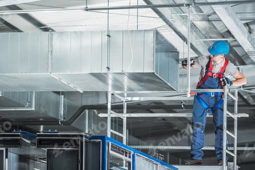 Preview: Construction HVAC Worker Installing Air Duct in Warehouse During Daylight Hours