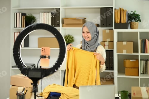 Preview: Young woman live streaming showcasing a product to her audience.