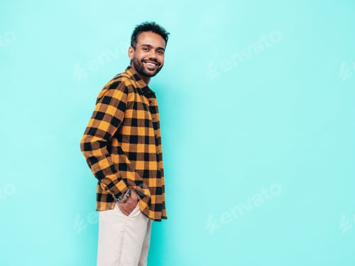 Preview: Portrait of young handsome man posing in studio