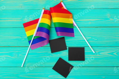 Preview: Bright rainbow gay flag on wooden background and blank space