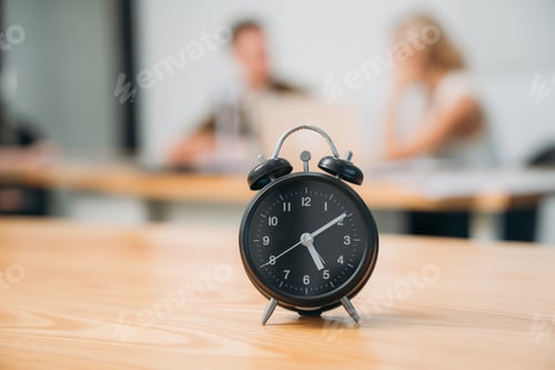 Preview: Workplace with alarm clock in modern style on background business meeting