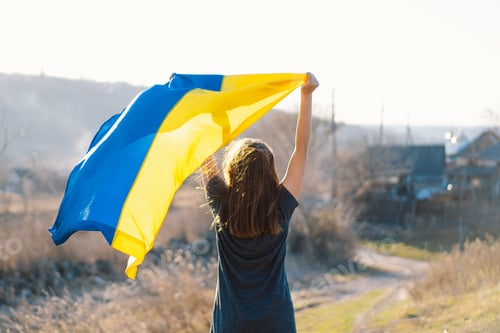 Preview: Woman holding a yellow and blue flag of Ukraine in outdoors. Independence Day