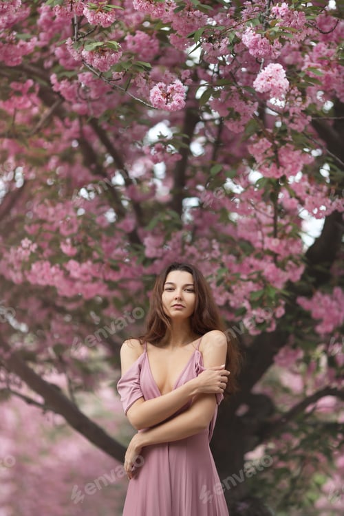 Preview: Woman at Blossoming Sakura Tree on Nature
