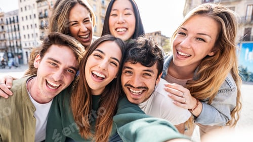 Preview: Multicultural young people smiling together at camera outside