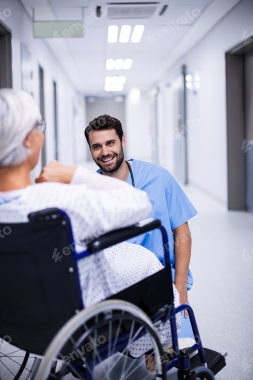 Preview: Male doctor interacting with senior patient on wheelchair