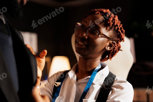 Preview: Close up of tailor helping customer