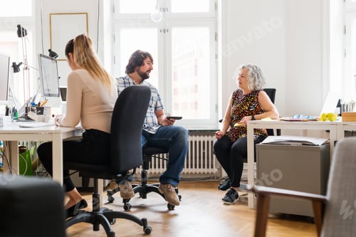 Preview: Coworkers talking in office