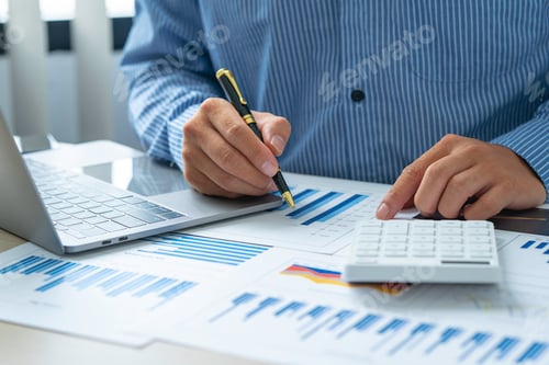 Preview: Close up account man hand using calculator for calculate and writing make a note with pen, financial