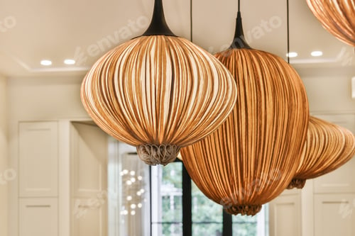 Preview: a close up of three large wooden chandeliers