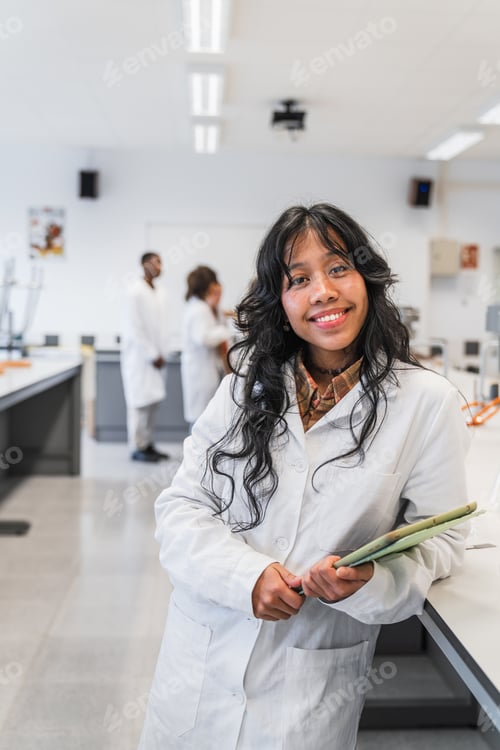 Preview: Young female chemistry student smiling in university science laboratory