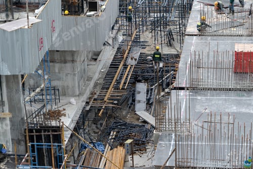 Preview: Aerial view of busy industrial construction site workers working. Development high rise building.