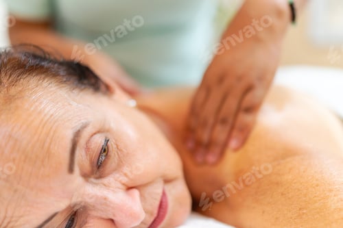 Preview: Mature woman receiving a back massage in the spa