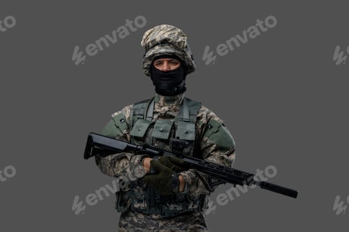 Preview: Military man with rifle dressed in camouflage uniform and helmet