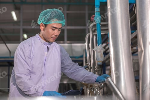 Preview: Worker Checking quality or checking stock of glass bottle in beverage factory.