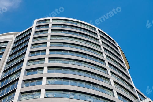 Preview: Office skyscraper high business building on blue sky background, looking up to glass modern building
