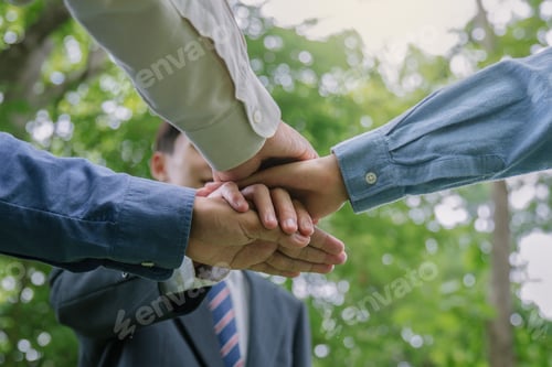 Preview: Business people putting hands together for CSR, corporate social responsibility.Community teamwork.