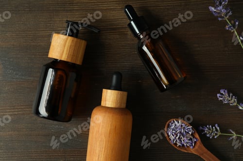 Preview: Lavender oil in bottles with lavender flowers on a dark background