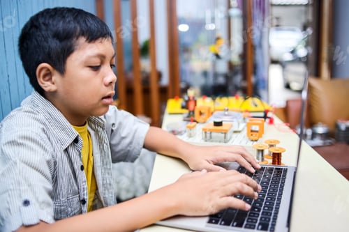 Preview: Asian boy studying with laptop