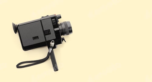 Preview: Super 8 film camera isolated on beige background