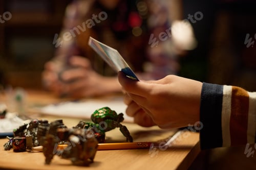 Preview: Hands of youthful boy choosing card