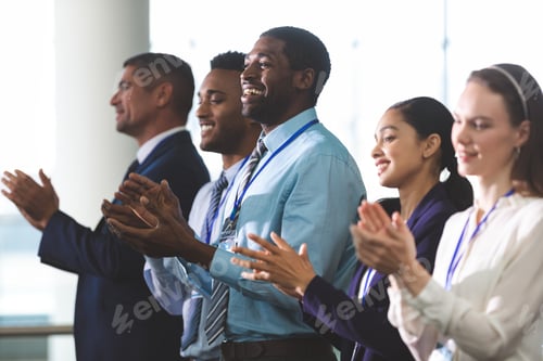 Preview: Business people applauding standing at business seminar in office building