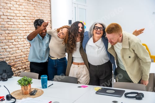 Preview: Diverse business team embracing laughing celebrating success