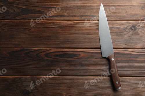 Preview: One knife on wooden table, top view. Space for text