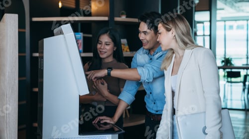 Preview: People are viewing a computer screen to check the availability of books for rent in the library.