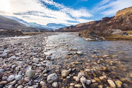 Preview: Flow of water in a fast mountain river with Mount Shahdag in the background