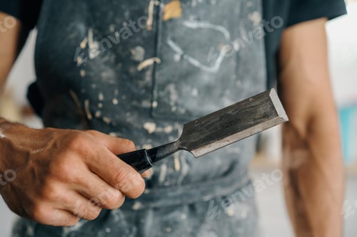 Preview: Male painter sculptor artisan works with spatula in art workshop