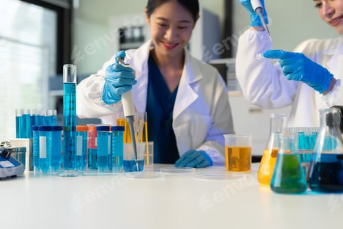 Preview: Scientist analyzing and dropping a sample into a glassware.