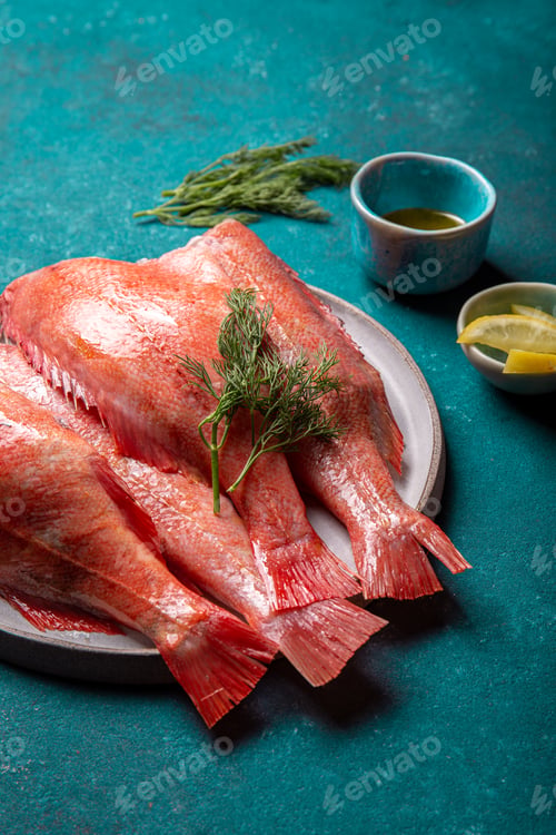 Preview: Fresh red sea bass on blue background.