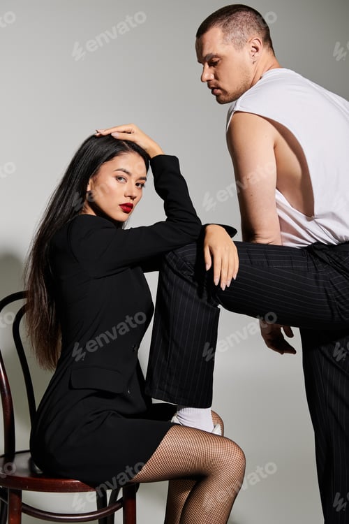 Preview: Young couple embraces their stylish looks, celebrating love in a studio setting together.