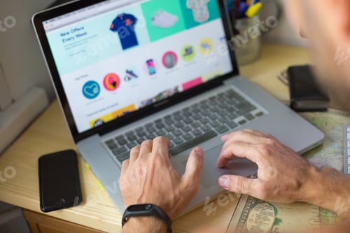 Preview: A young man uses a laptop to place an online order on the Internet. Online shopping.