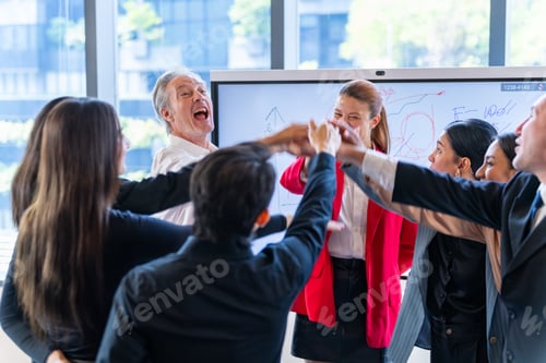 Preview: Diverse business team celebrates success with a high five huddle in a modern office meeting room