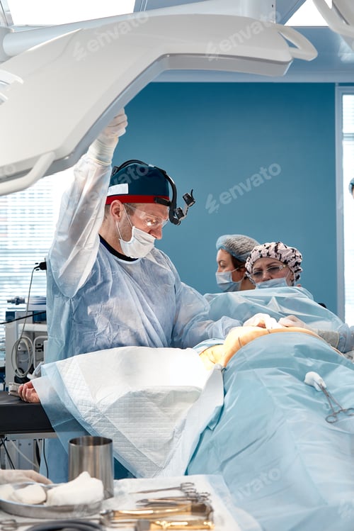 Preview: Team surgeon at work in operating room.