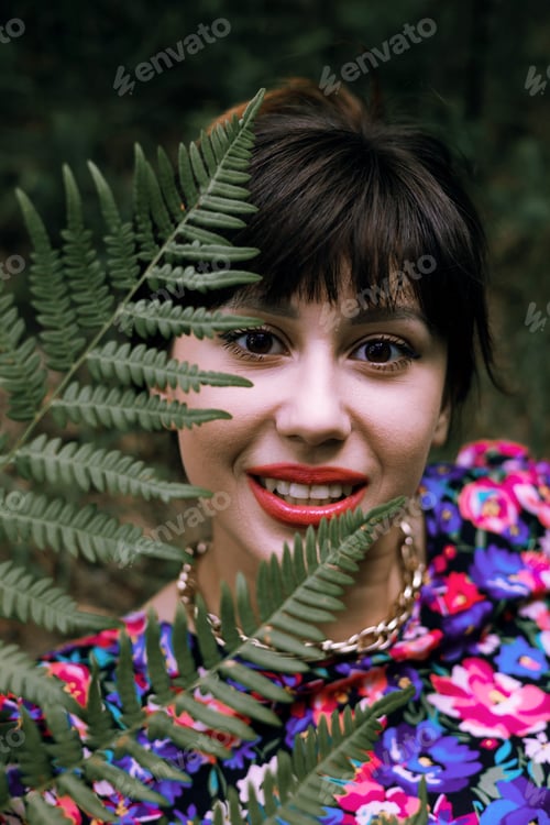 Preview: Romantic portrait of a woman in a fern in the forest. Art woman natural makeup resting in nature. Gr